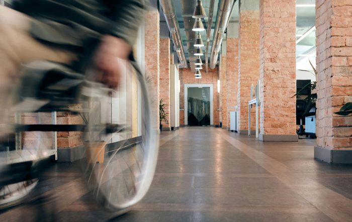 Wheelchair bound person rolling down and past at speed.